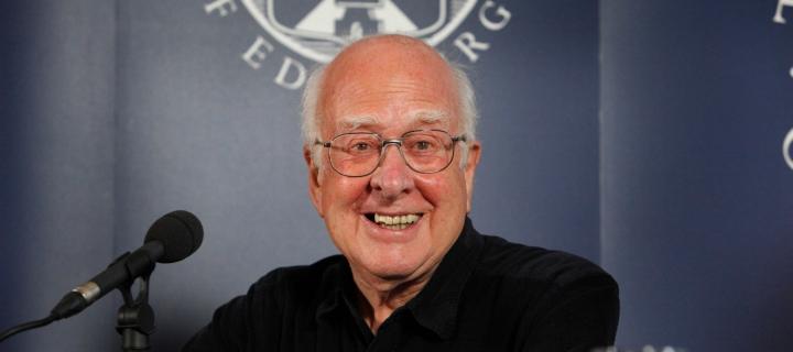 Professor Peter Higgs with mic at news conference