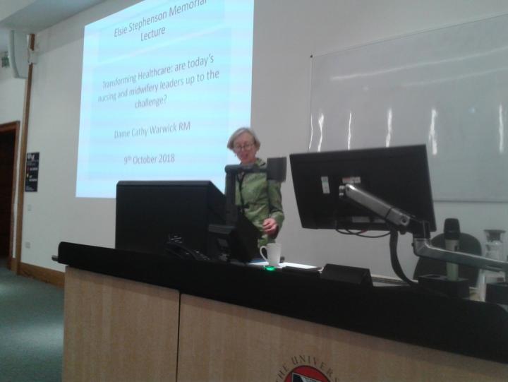 Warwick presenting lecture in front of screen