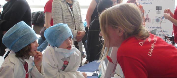 Research nurse talks to children