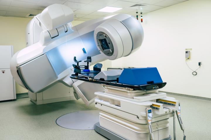 Photo of an advanced linear accelerator used for cancer radiotherapy in a modern hospital suite