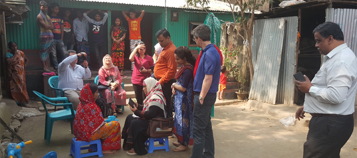 Group of people talking outside health clinic in Bangladesh 