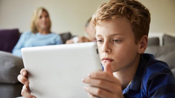 Boy looking at a tablet screen