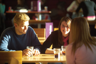 group of postgraduate students chatting in bar
