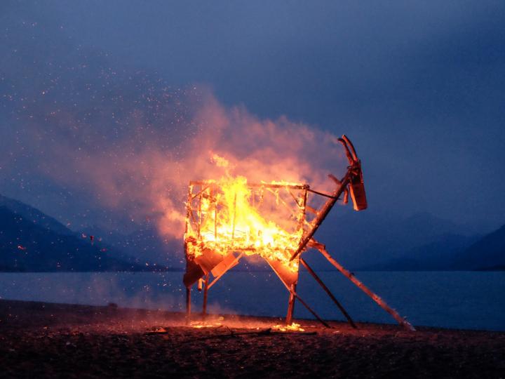 A wooden horse is being burnt in the beach as part of the solstice traditions.