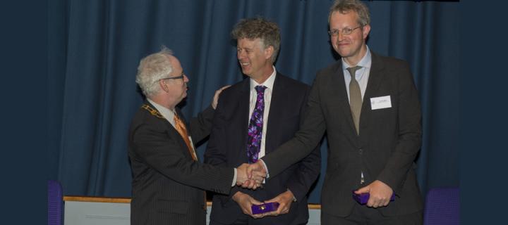 Jon Stone (right) and Alan Carson (centre) receive the RPsych President's Medal