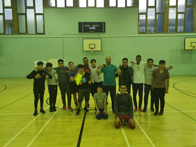 Photograph of Syrian Teenager Tutoring and Education Programmes social trips. A group of students in a gym hall after playing football. 