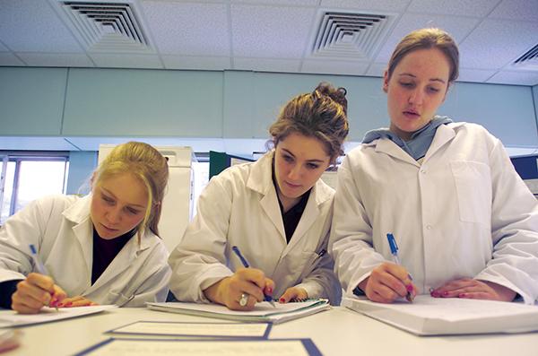 Female student scientists in a lab annual review 2014_15