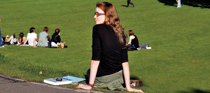 Photo of a student sitting in Princes Street gardens