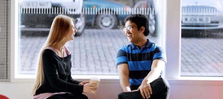 Photo of students chatting in the Business School cafe