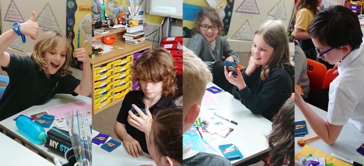 School children playing the Supercytes card game together