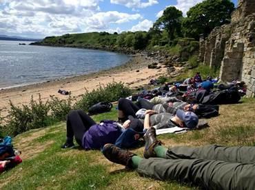 People lying down by a beach