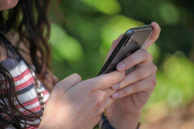 female teenager on phone texting