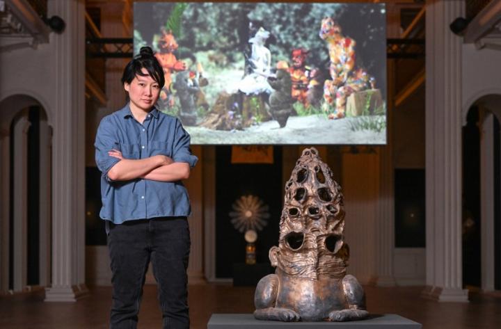 Artist Candice Lin standing next to one of her sculptures in the Talbot Rice Gallery