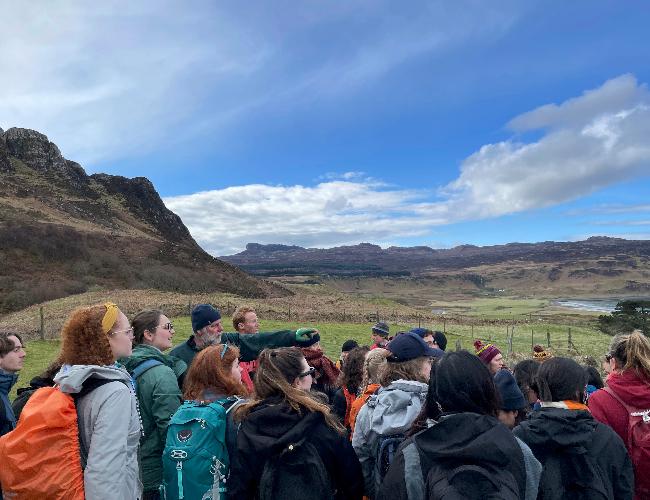 Students stand in green landscape in Isle of Eigg