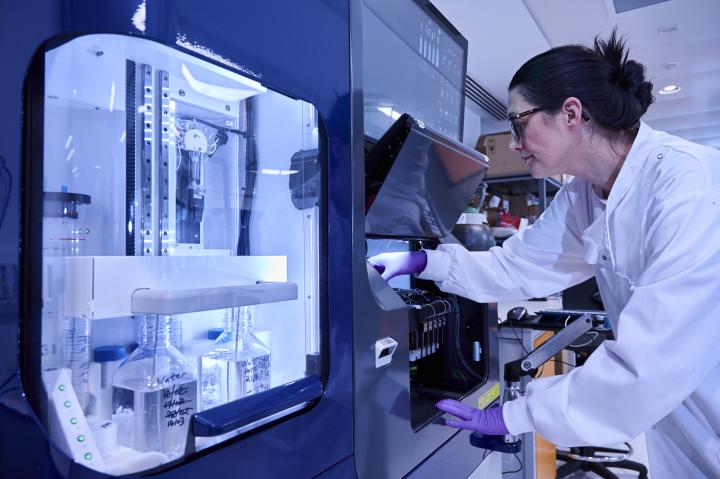 Image of researcher working in fume hood inside laboratory