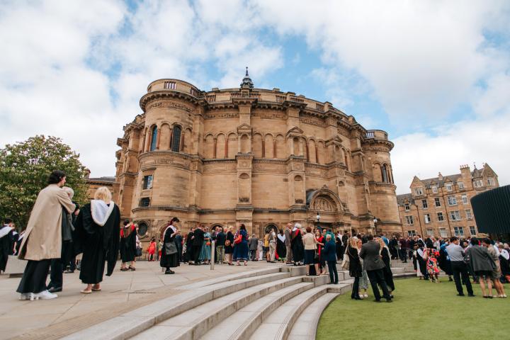 Graduating students gather outside McEwan hall, surrounded by family and friends