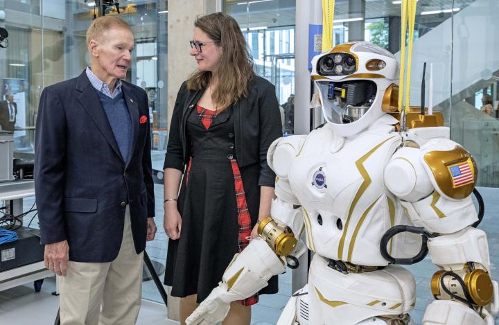 NASA Administrator Nelson stands with Sector Business Development Lead, Kristina Tamane, with Valkyrie robot in foreground