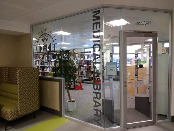 A photograph of the Western General Library entrance, which is a glass entrance with Medical Library written sideways and a door