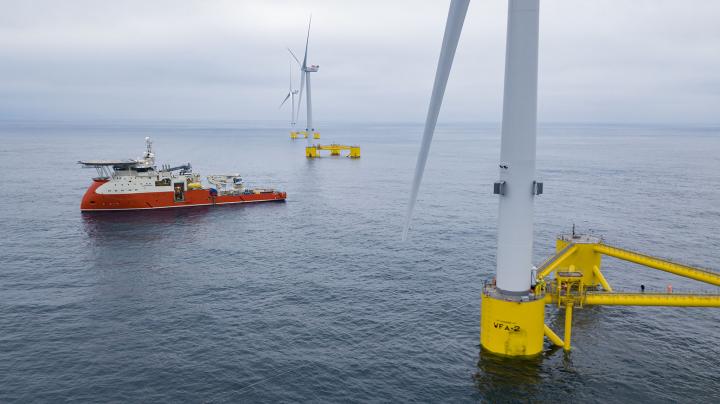 image of wind turbines mounted in ocean 