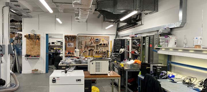 Photo of the workshop, with racks of tools and equipment, in the JCMB building.