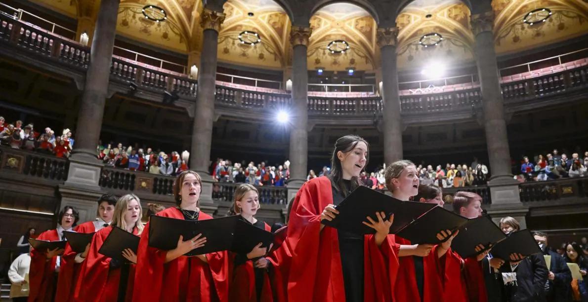 Carol singers singing at Christmas Carol Service