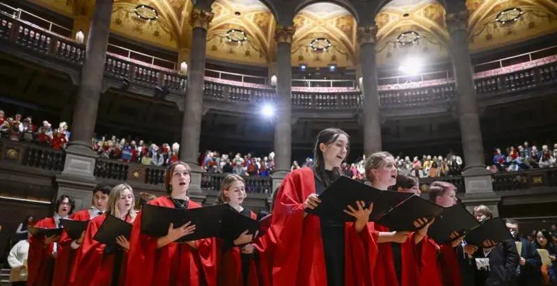 Carol singers singing at Christmas Carol Service