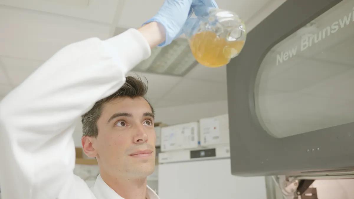 Student swills liquid in beaker