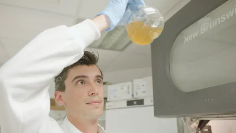 Student swills liquid in beaker