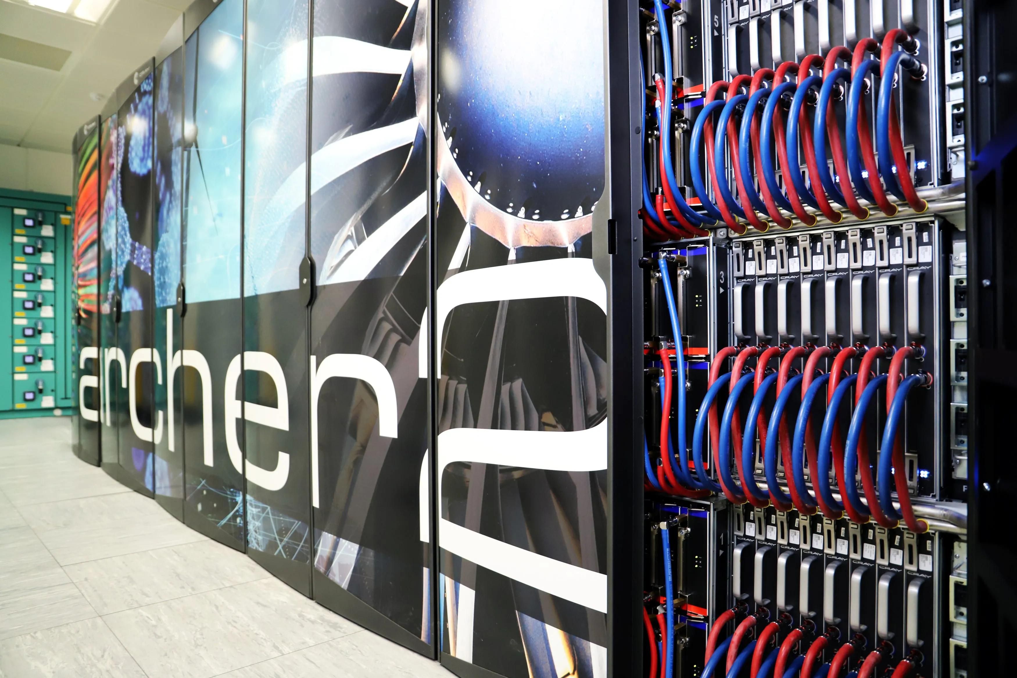 A close-up image of the ARCHER2 supercomputer, showing a large rack of thick blue and red cables