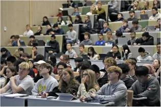 A lecture theatre full of students seen from the point of view of a lecturer