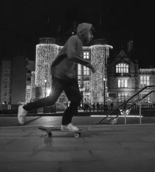 A skateboarder in front of Teviot Row House