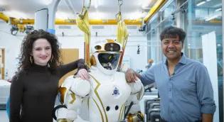 PhD student Elle Miller (left) and Professor Sethu Vijayakumar (right) standing with the NASA Valkyrie humanoid robot