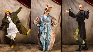 Characters in the ECA Performance Costume Show 2026 in front of a grey backdrop. The Businessman, donning an oversized black and yellow suit with a giant tie emblazoned with numbers. Centre: Mad Hatter, dressed in hues of blues and gold with a gold-horned headdress. Right: The Master of Ceremonies from Cabaret, dressed in a fully tailored 1920s tailcoat and uniform breeches with exaggerated insect features.