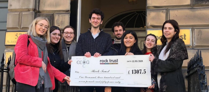 photo shows geog soc students giving charity a cheque for money raised