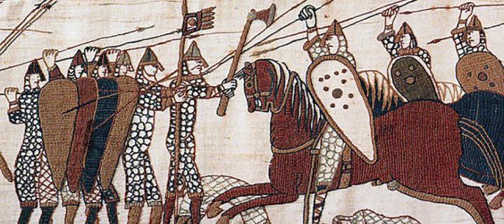 A scene from the Bayeux Tapestry showing horsemen throwing spears against men with shields