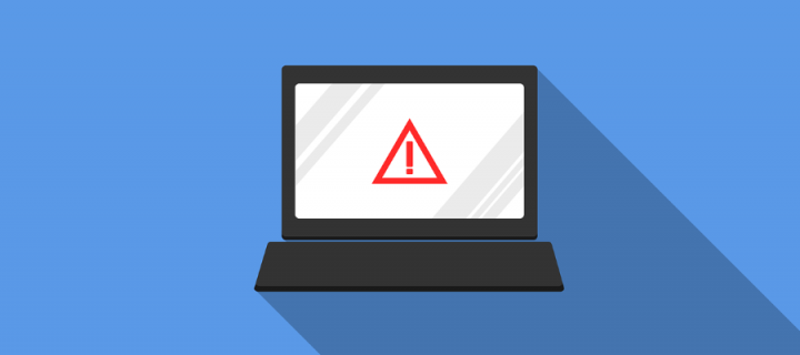 A laptop screen showing a warning symbol