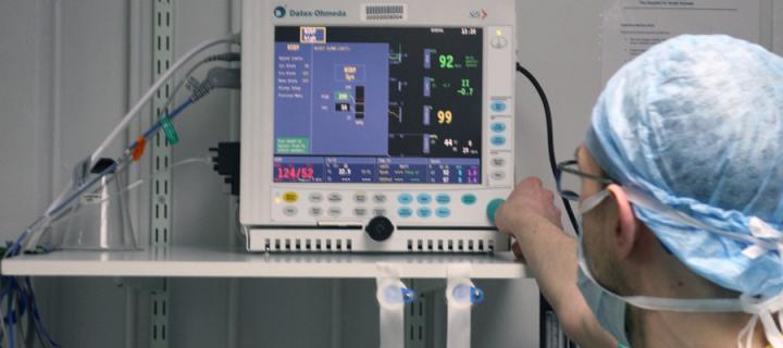 A vet interacting with an Anesthesia monitor 