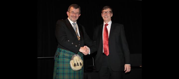 Prof Walls bearing the chain of office of President of IADR, having been inducted by his predecessor Prof Jukka Meurman