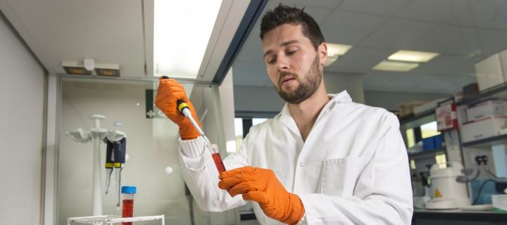 Scientist with orange gloves