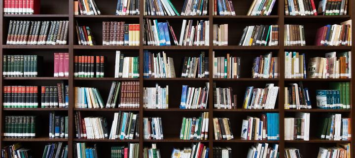 A photo of a large bookcase with lots of books on every shelf