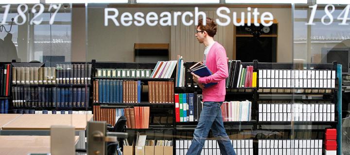 Photo of a man walking through the library's research suite