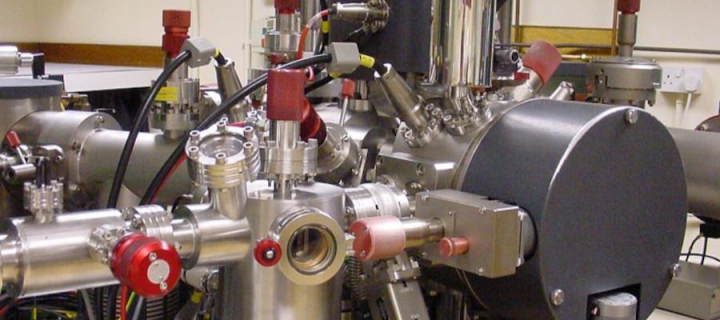 A close up of ion-probe scientific equipment showing pipes and seals