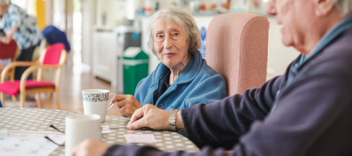 photo of a lady and man in a care home setting