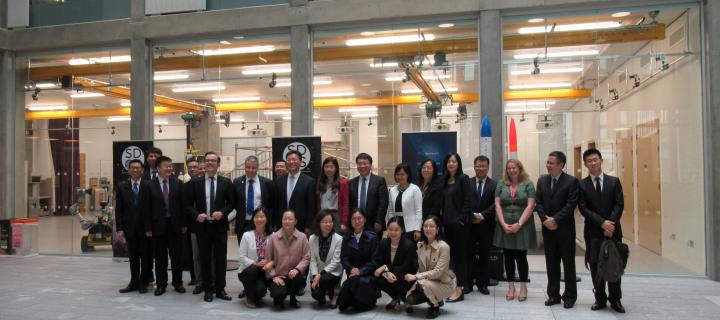 Group shot of Chinese delegation in Bayes atrium