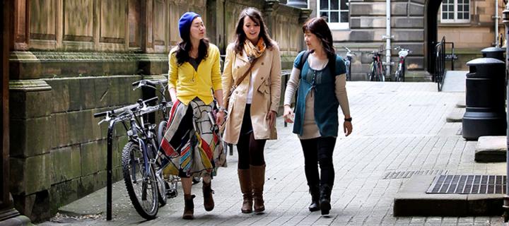 Three students walking outside the Old Medical School