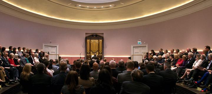 An audience enjoying a performance in the oval concert hall