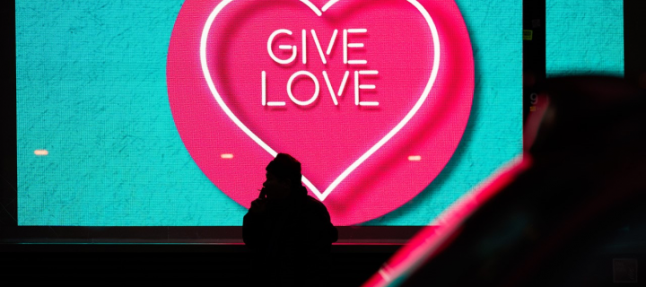Blue and pink sign with the words give love