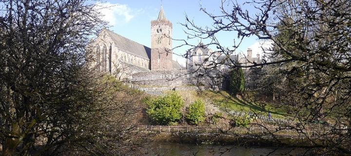 Dunblane Cathedral through the trees, with river in the foreground