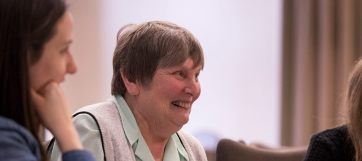 Elisabeth Erhlich laughing while speaking with others