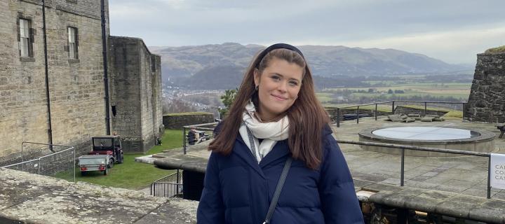 Student Ellie standing near castle